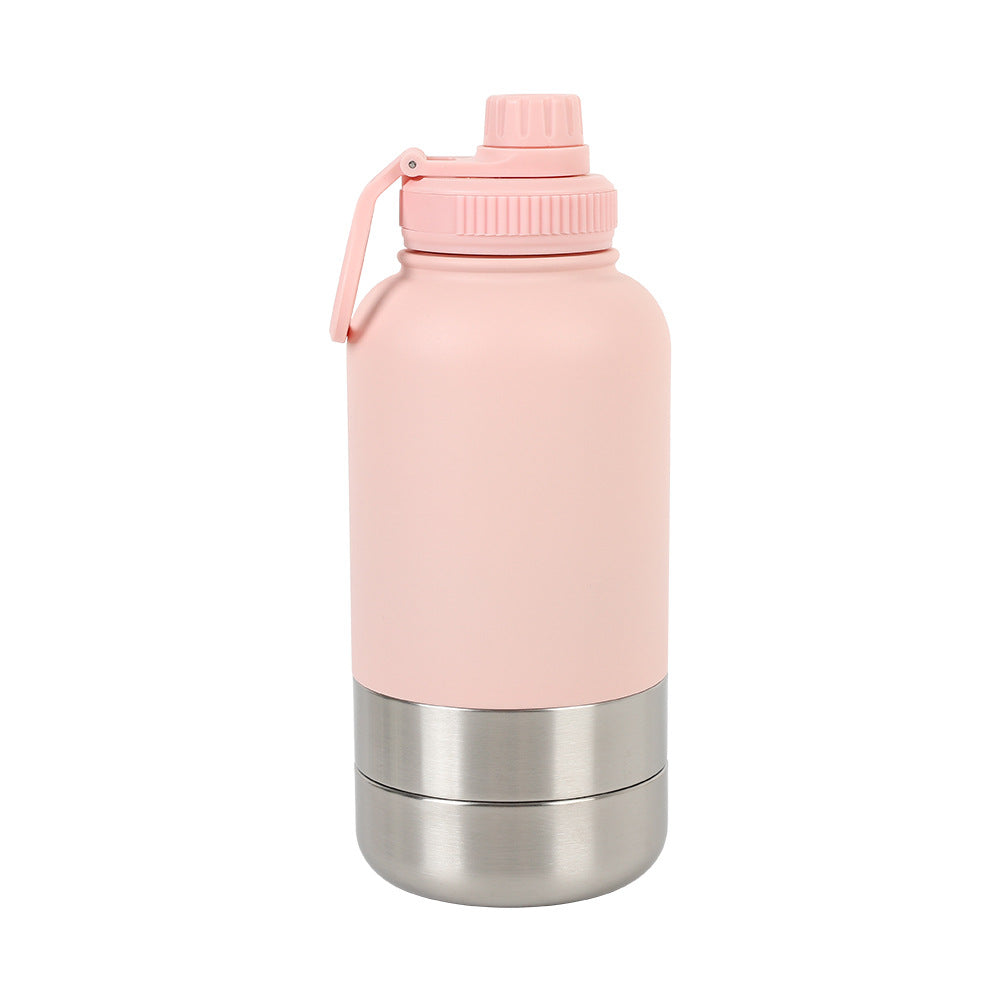 A pink and silver travel water bottle with a snack compartment for dogs, placed on a wooden surface outdoors.